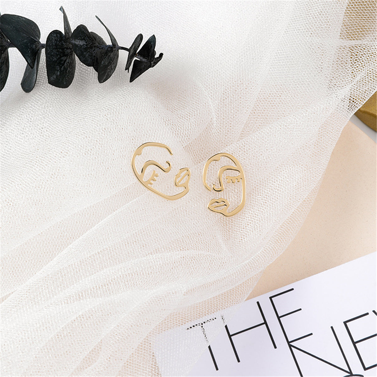 Chic 18K gold-plated abstract face stud earrings with captivating eyes, a must-have accessory for any jewelry lover.
