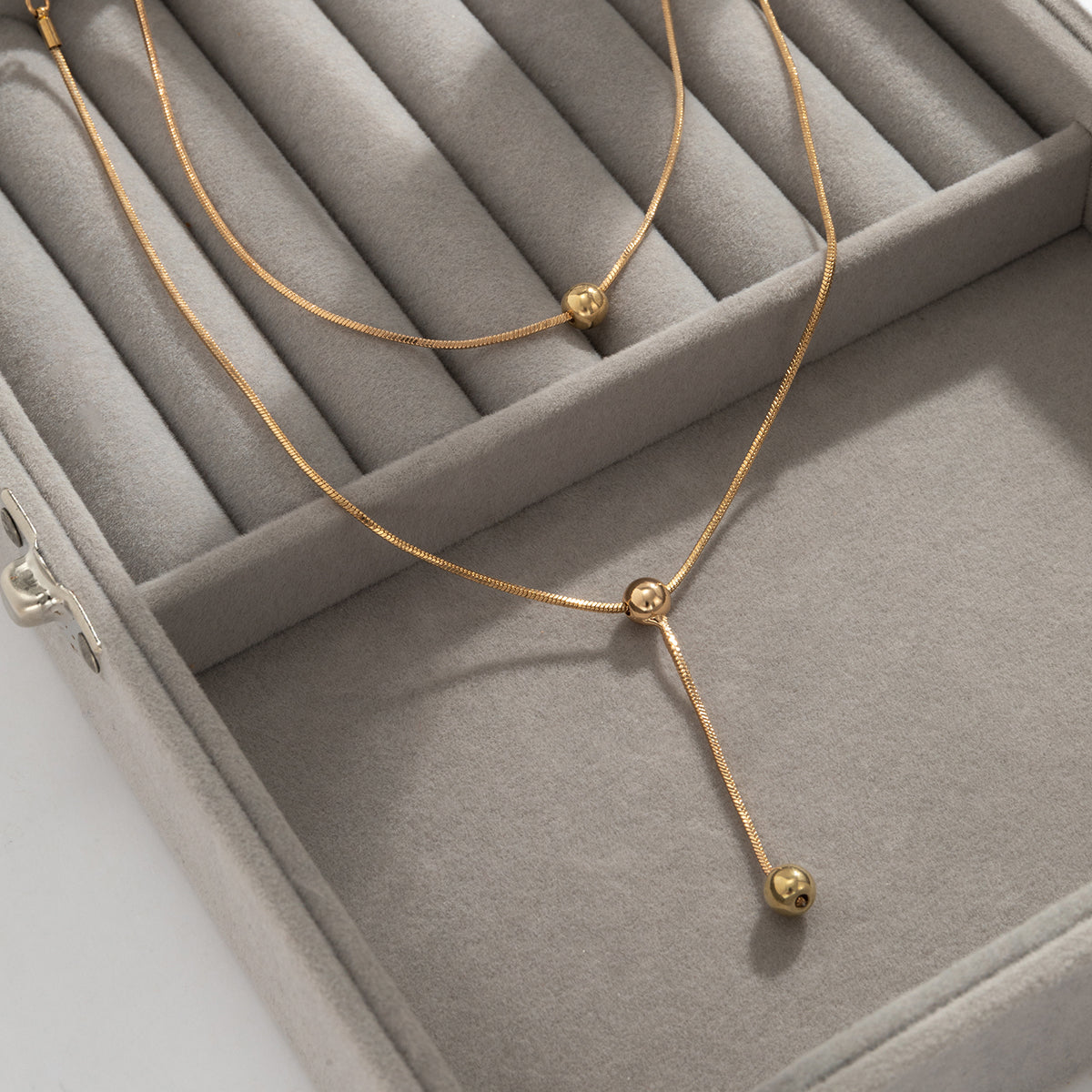 Exquisite 18K gold-plated necklace with two charming beads, elevating your style with a touch of luxury.