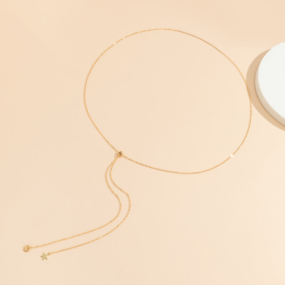 Chic 18K gold-plated waist chain with a long chain and a petite 'Love' star pendant, elevating your fashion game effortlessly.