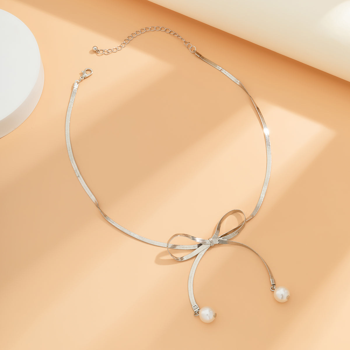 Silver-Plated and Pearl Bow Choker Necklace, silver pendant necklace for women, everyday style, detail close-up