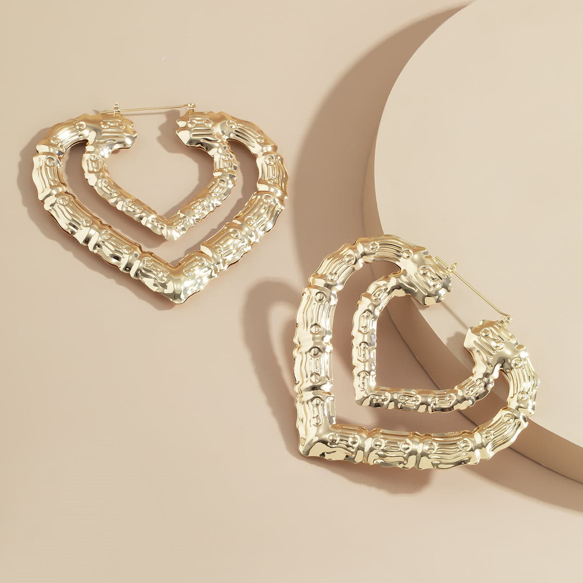 Beautifully designed heart-shaped earrings, layered in 18K gold-plated bamboo, perfect for any fashion-forward outfit.