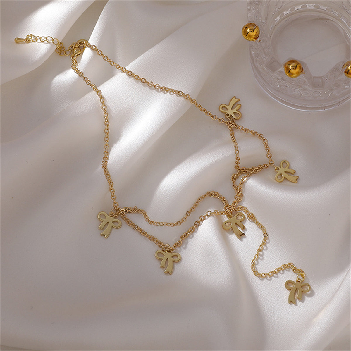Beautiful 18K gold-plated choker necklace adorned with bows, a perfect blend of style and sentiment.
