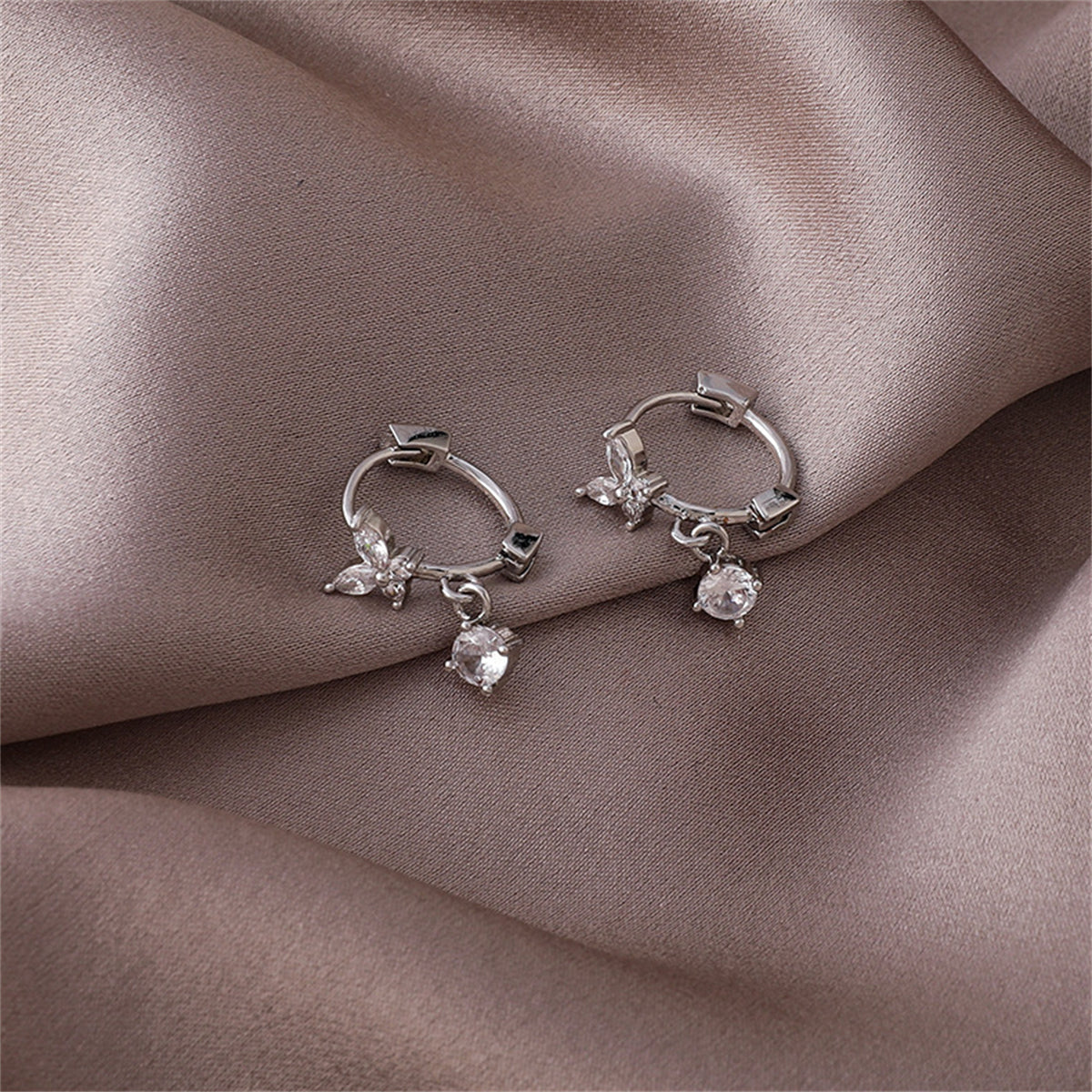 Cubic Zirconia and Silver-Plated Butterfly Huggie Earrings, silver huggie earrings, dainty minimalist design, detail close-up