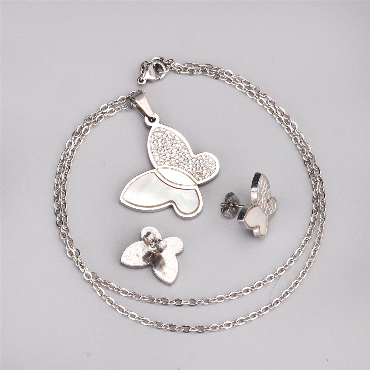 White Shell and Silver-Plated Butterfly Stud Earrings and Pendant Necklace, silver stud earrings for women, detail close-up