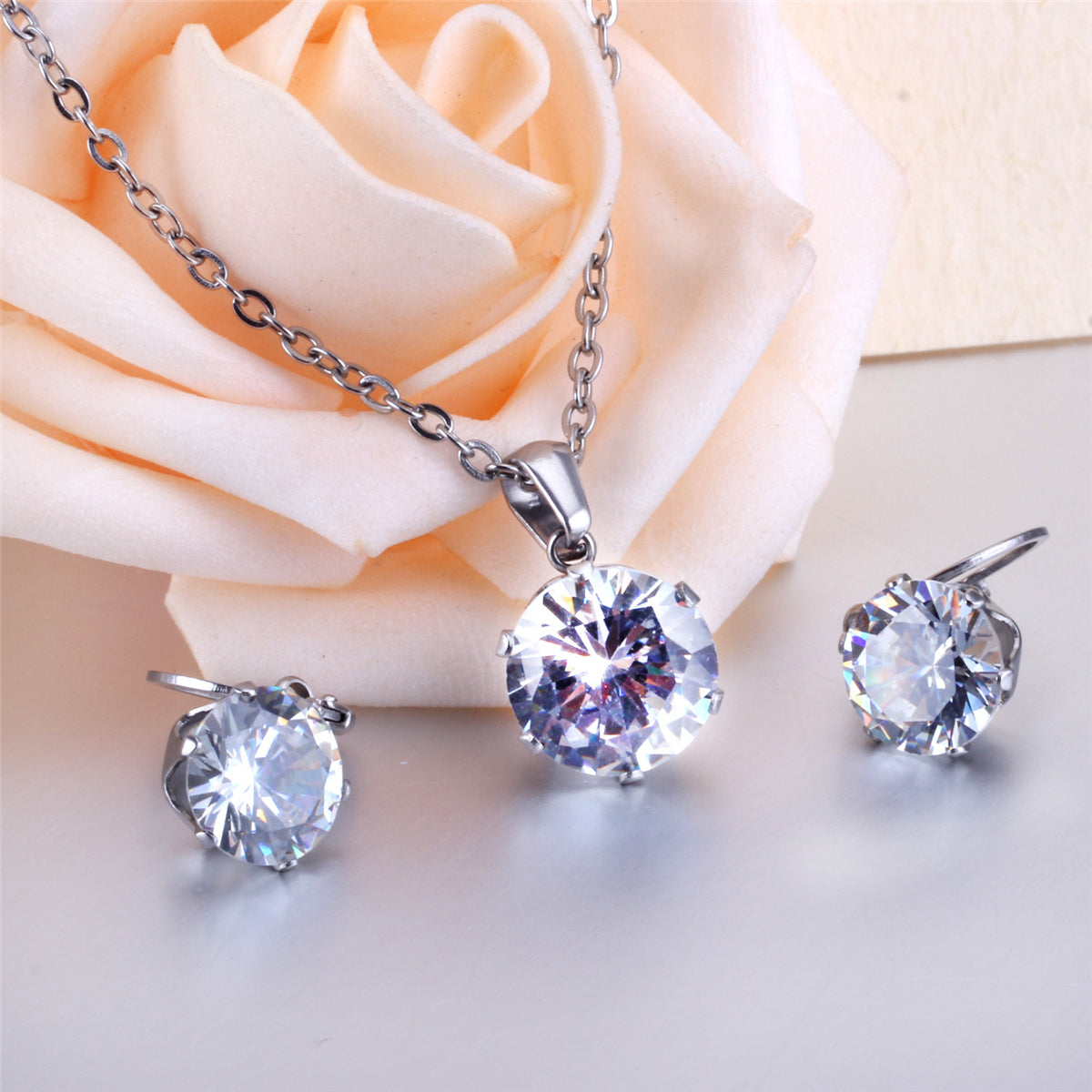 Cubic Zirconia and Silver-Plated Drop Huggie Earrings and Pendant Necklace, silver huggie earrings, detail close-up