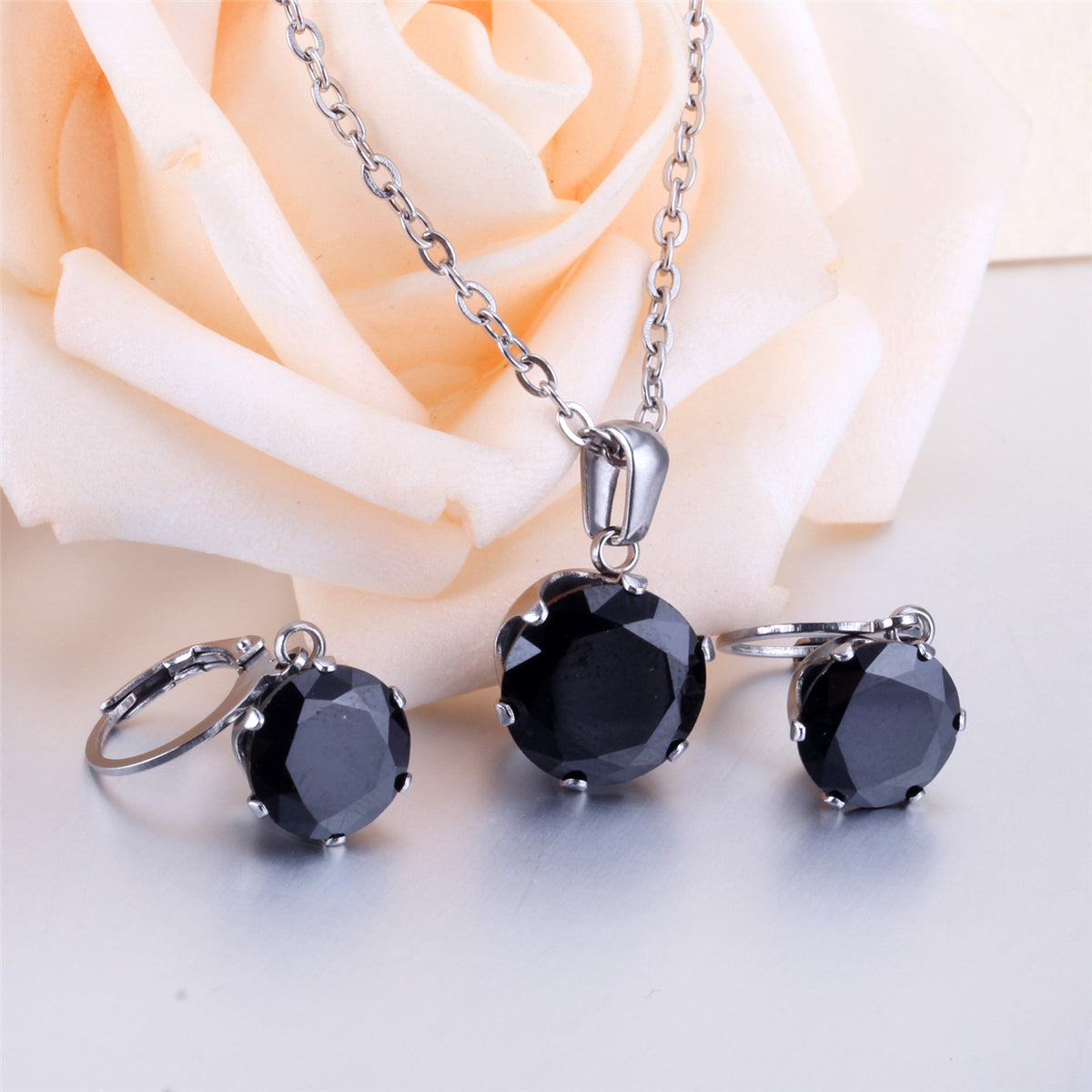 Black Cubic Zirconia and Silver-Plated Round Pendant Necklace and Huggie Earrings, silver huggie earrings, detail close-up