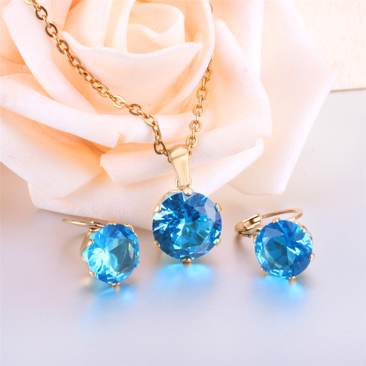 Light Blue Cubic Zirconia and 18K Gold-Plated Huggie Earrings and Pendant Necklace, gold huggie earrings, side view