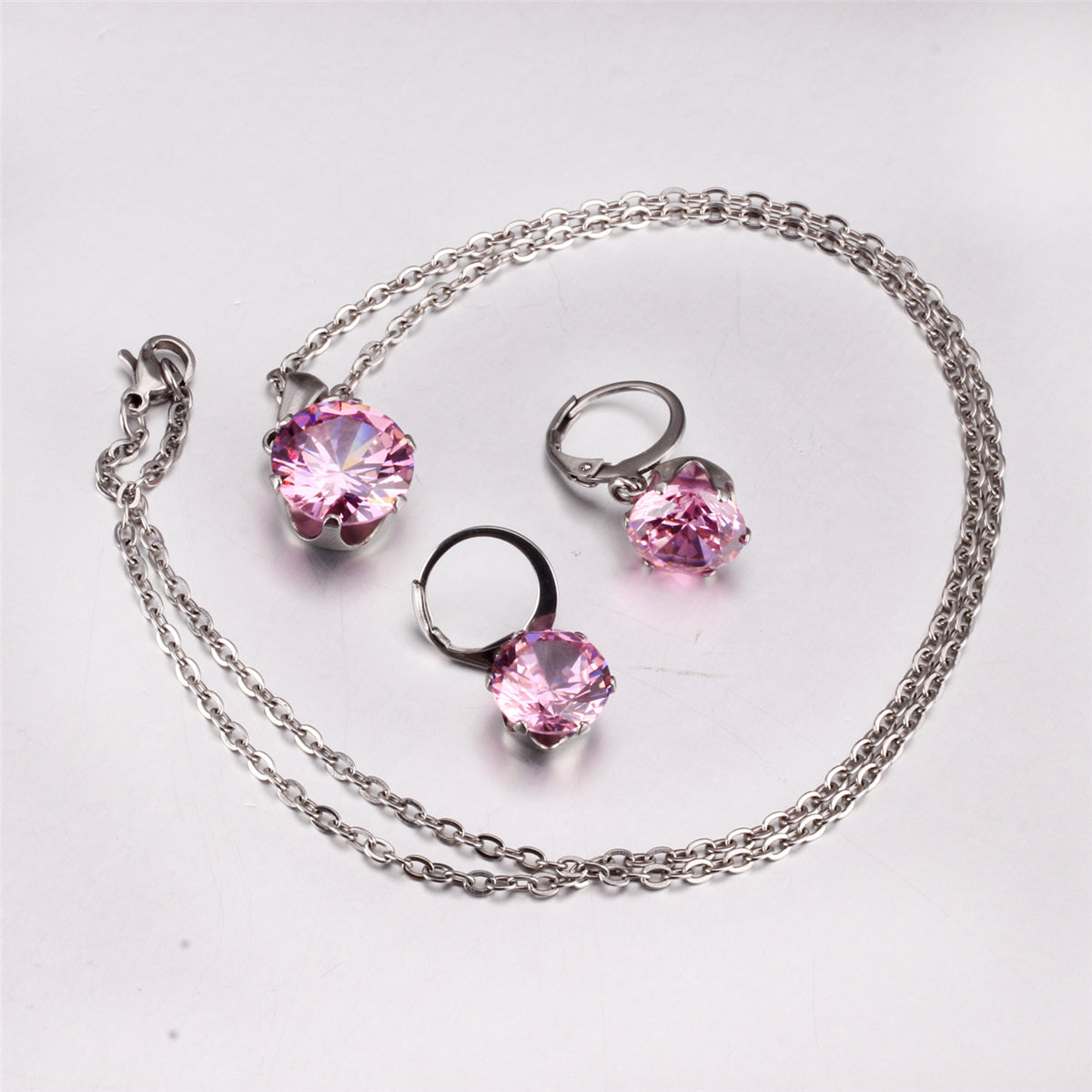 Pink Cubic Zirconia and Silver-Plated Huggie Earrings and Pendant Necklace, silver huggie earrings, side view