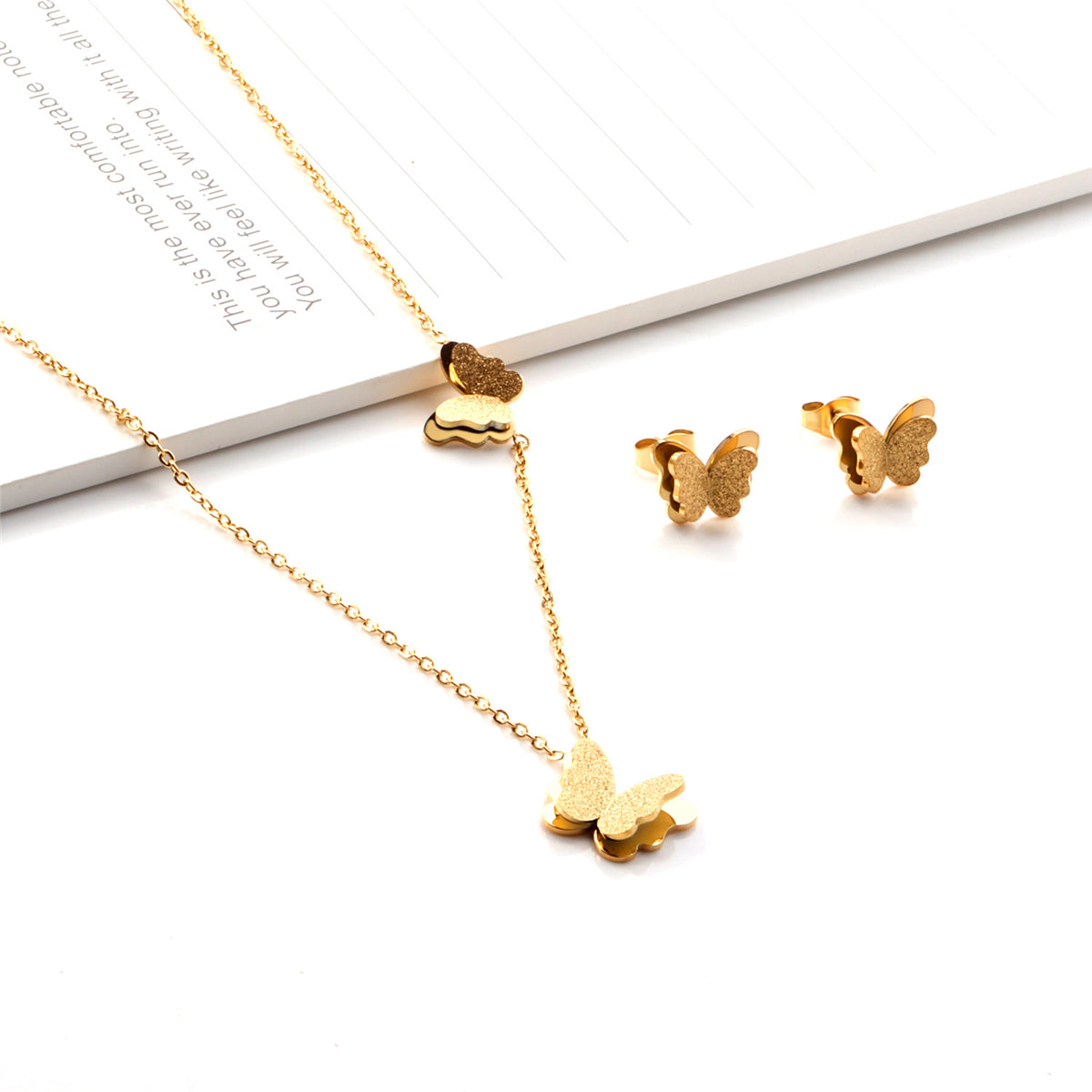 Stunning 18K gold-plated butterfly jewelry set featuring delicate earrings and a pendant necklace for a chic look.