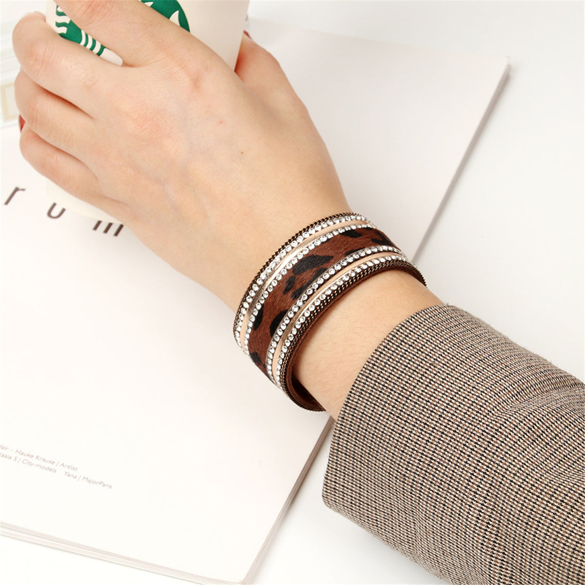 Opulent leopard print leather cuff bracelet, complete with a gold-plated clasp and adorned with 18K gold plating and cubic zirconia.