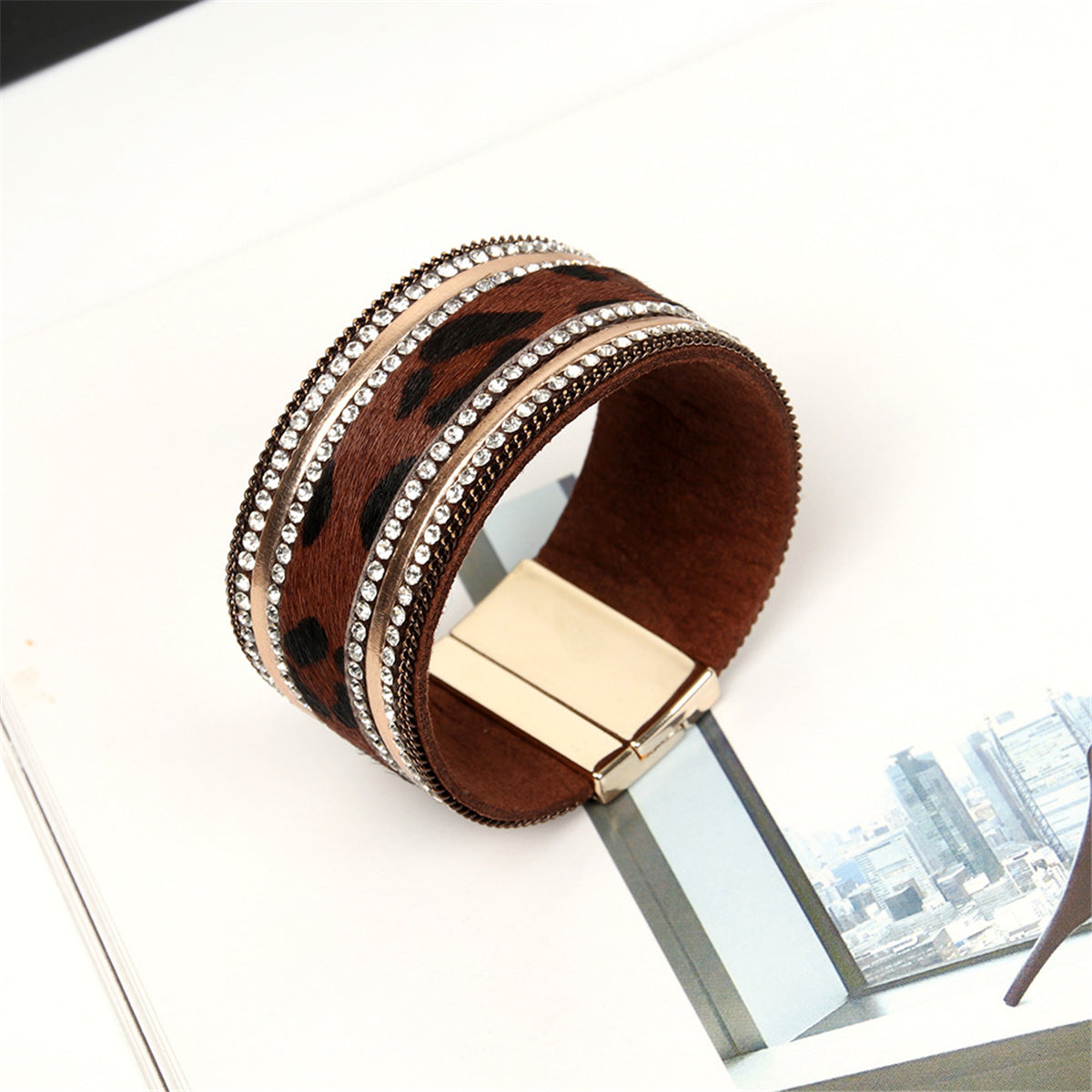 Luxurious leopard print leather cuff bracelet with a gold-plated clasp, embellished with 18K gold plating and sparkling cubic zirconia.