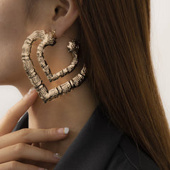 Heart-shaped, 18K gold-plated bamboo earrings, elegantly layered for a unique and stylish accessory.