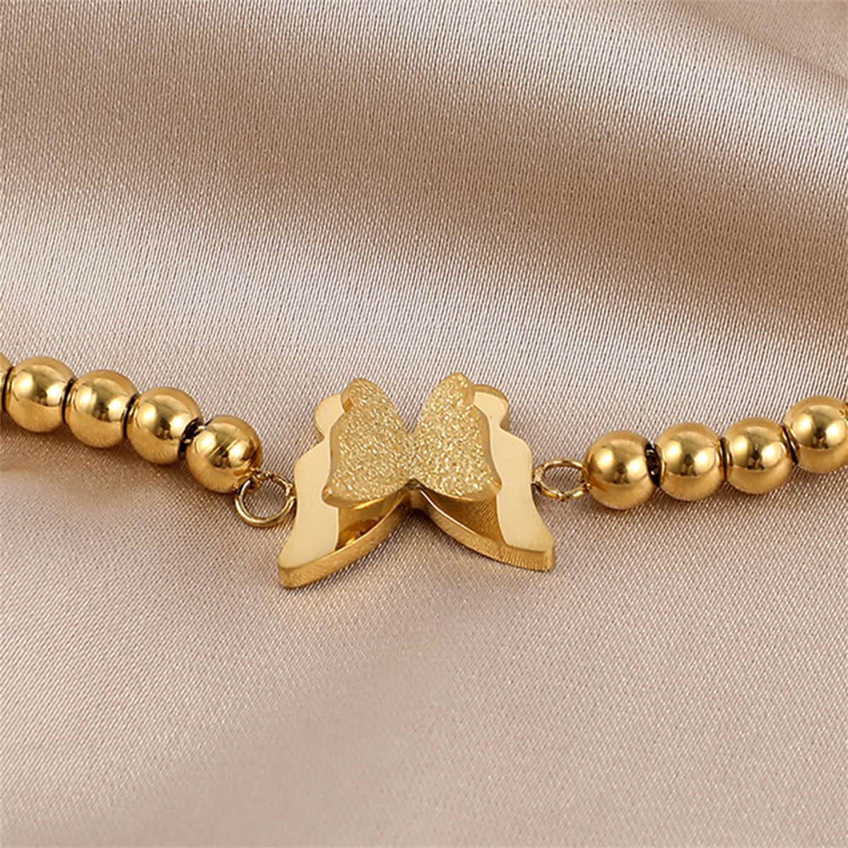 Dazzling 18K gold-plated butterfly beaded charm bracelet, a chic accessory that enhances any ensemble with elegance.