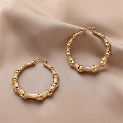 Elegant 18K gold-plated bamboo hoop earrings, showcasing a unique design that adds a touch of sophistication to any outfit.