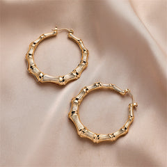 Eye-catching 18K gold-plated bamboo hoop earrings, designed to bring a trendy flair to your jewelry collection.