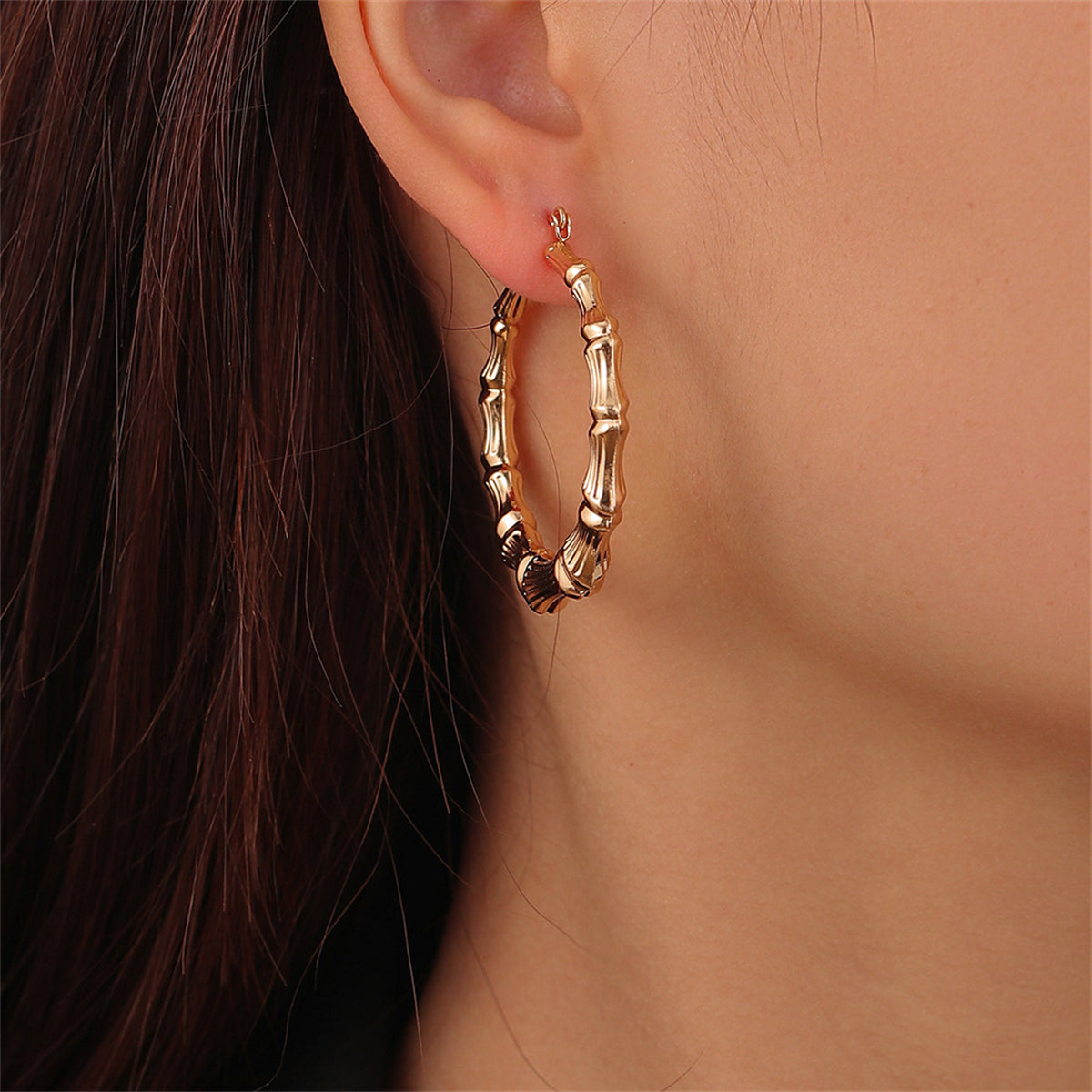 Luxurious 18K gold-plated bamboo hoop earrings, a must-have accessory that combines elegance and contemporary style effortlessly.