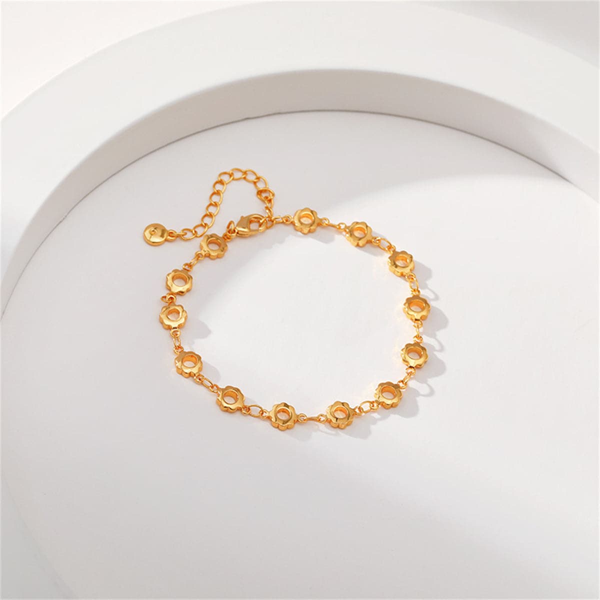 Stylish 18K gold-plated bracelet with small circular elements and a chain, highlighted by open flower motifs.