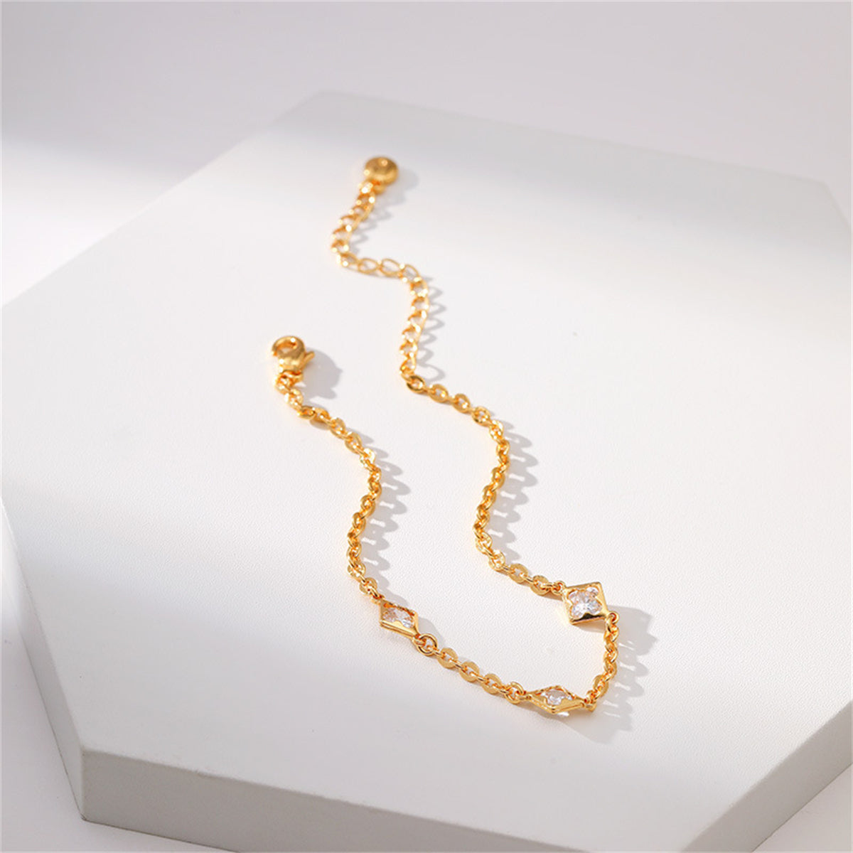 A stunning gold-plated bracelet with diamonds and a clover charm, exemplifying exquisite craftsmanship and beauty.