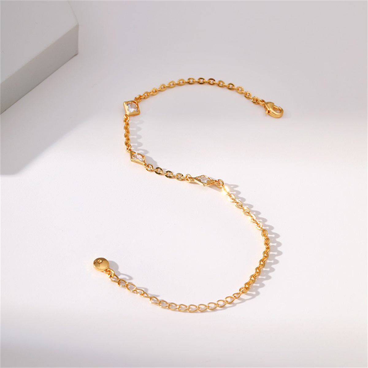Elegant gold-plated bracelet featuring diamonds and a clover charm, perfect for adding a touch of sophistication.