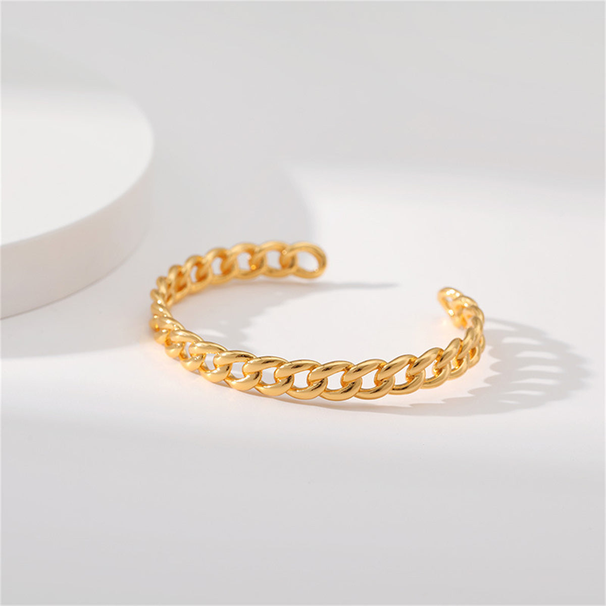 18K gold-plated cuff bracelet with a unique twisted design, perfect for adding a touch of elegance to any outfit.