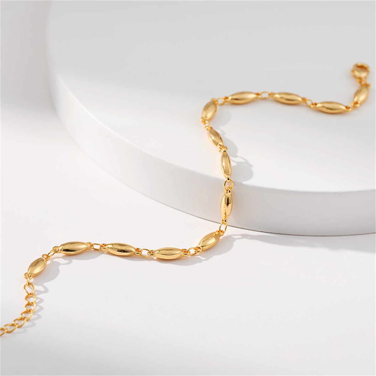 A luxurious 18K gold-plated olive chain bracelet, beautifully accented with small oval beads for a chic look.