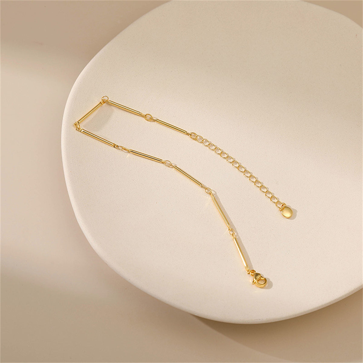 Stunning 18K gold-plated bar station bracelet crafted from a single chain link, perfect for adding elegance to any outfit.