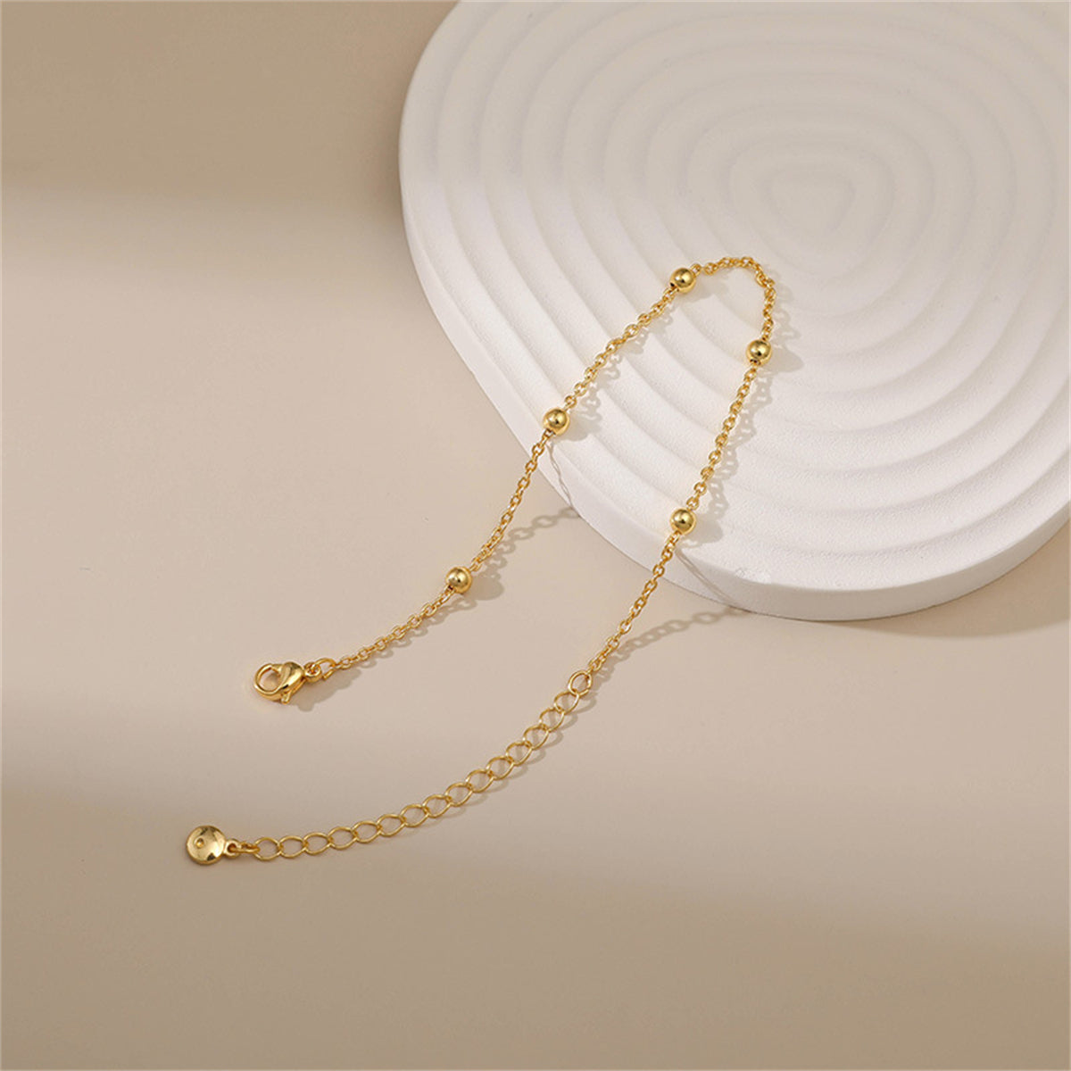 Exquisite 18K gold-plated bracelet showcasing a single strand of gold beads, a must-have for elegant and stylish looks.