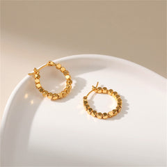 Dazzling 18k gold round hoop earrings with a beaded detail, ideal for elevating any outfit with a touch of glamour.