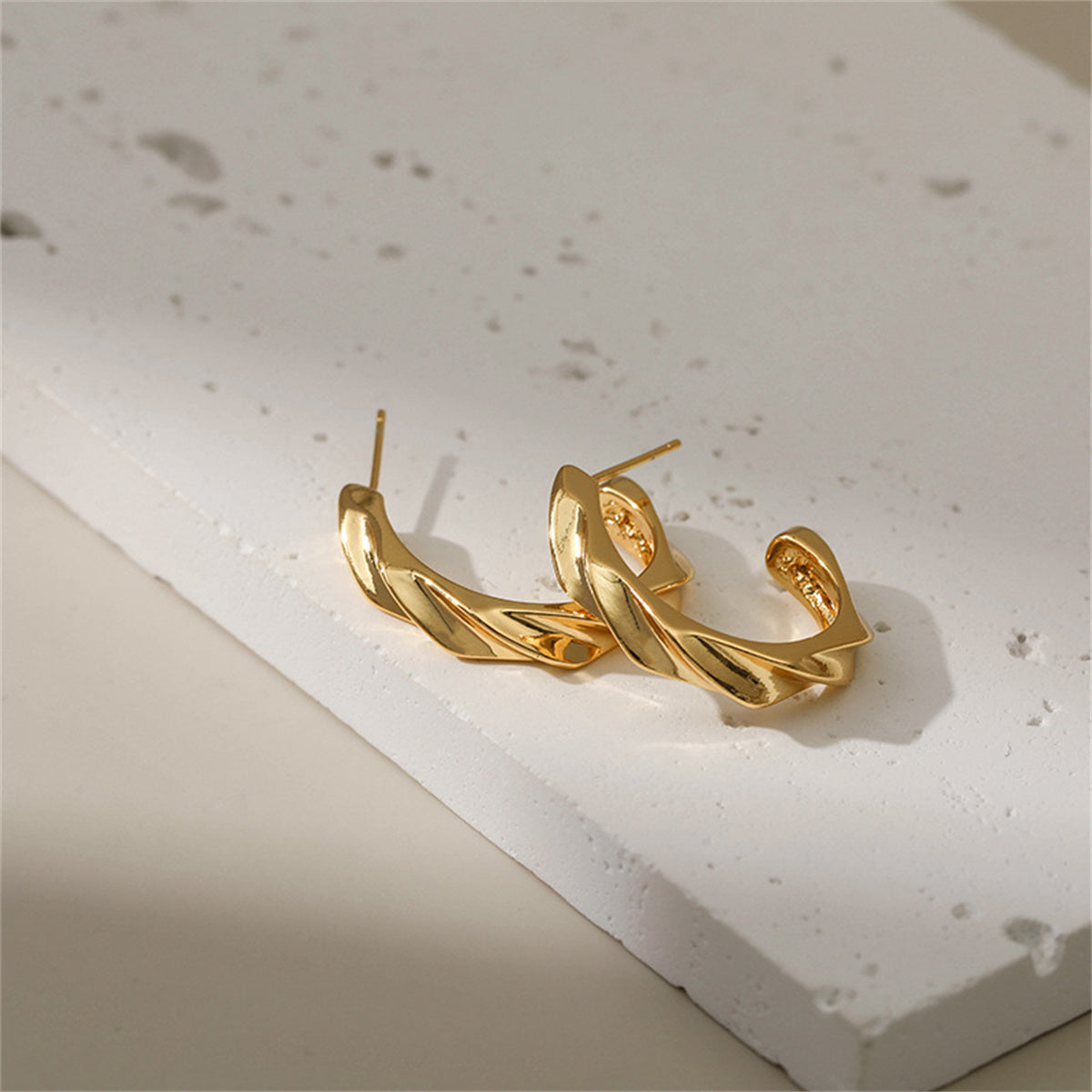 Chic 18K gold-plated huggie earrings, designed to complement any ensemble with their timeless appeal.
