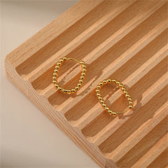 Stunning 18k gold ball hoop earrings, designed with a beaded U-shape for a modern and fashionable appeal.