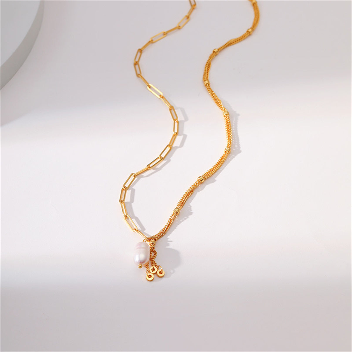 Stylish gold-plated necklace with a pearl pendant, designed with multiple chains for a chic look.