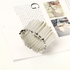 A silver-plated vat bangle featuring a prominent, intricate metal design, showcasing elegance and craftsmanship.