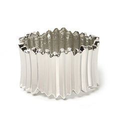 A stylish silver-plated vat bangle adorned with a large, eye-catching metal design, perfect for any occasion.