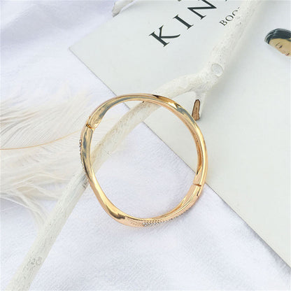 Cubic Zirconia and 18K Gold-Plated Twisted Bangle, gold bangle bracelet, botanical inspired, styled look