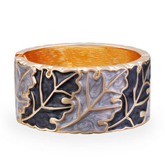 An elegant oak leaf bangle featuring gold and silver accents, crafted with gray and black enamel and 18K gold plating.