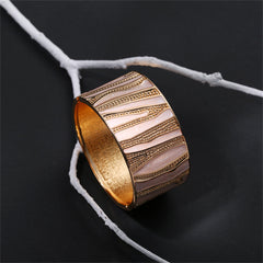 Gold and white branch-patterned bracelet, designed with white enamel and plated in 18K gold for a luxurious finish.