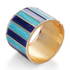 A chic blue and gold striped cuff bracelet, made from blue enamel and enhanced with 18K gold plating.
