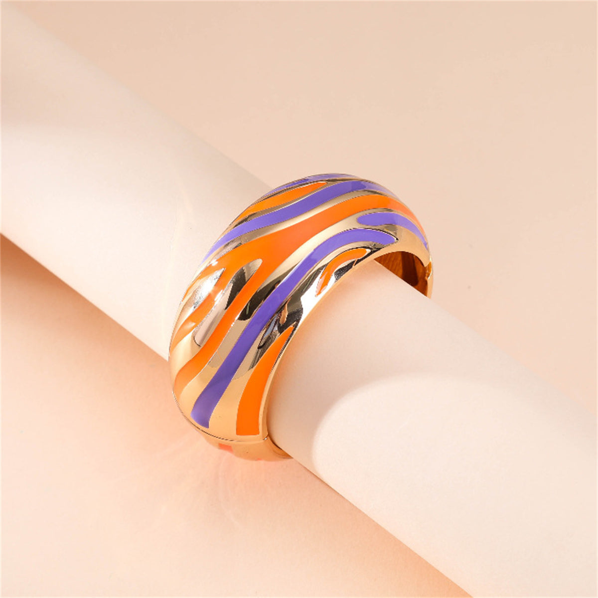 An eye-catching bracelet with orange and blue stripes, embellished with gold accents and 18K gold-plated details.