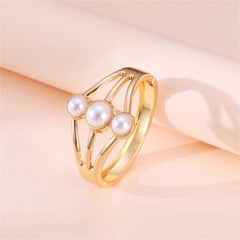 An exquisite gold-plated bangle embellished with three white pearls, highlighting a refined layered bangle aesthetic.
