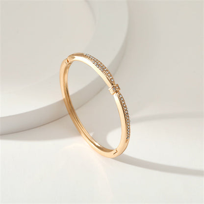 Cubic Zirconia and 18K Gold-Plated Knot Bangle, gold bangle bracelet, vintage-inspired design, detail close-up
