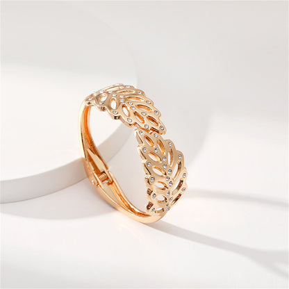 Cubic Zirconia and 18K Gold-Plated Rattan Hinged Bangle, gold bangle bracelet, botanical inspired, side view