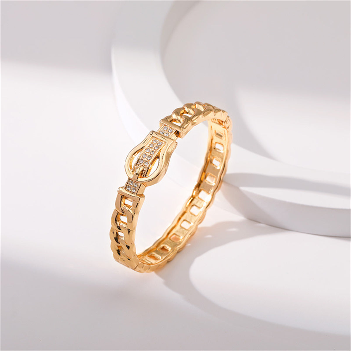 Elegant yellow gold bracelet with diamonds, showcasing a cubic zirconia and 18K gold-plated belt buckle bangle style.