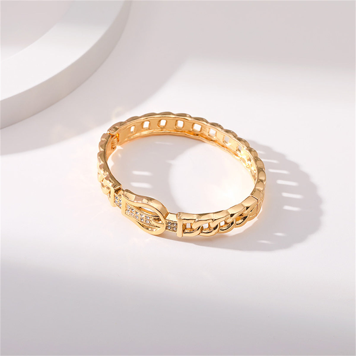 Stunning yellow gold bracelet featuring diamonds, complemented by a cubic zirconia and an 18K gold-plated belt buckle.