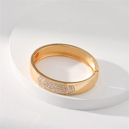 Cubic Zirconia and 18K Gold-Plated Arrow Bangle, gold bangle bracelet, vintage-inspired design, lifestyle look