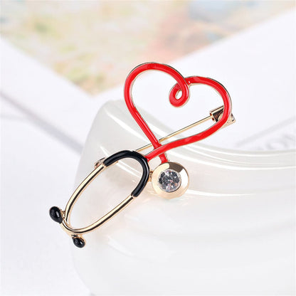 Cubic Zirconia and Enamel 18K Gold-Plated Stethoscope Brooch, gold brooch pin, botanical inspired, detail close-up