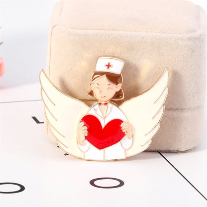 Red Enamel and 18K Gold-Plated Nurse Wing Heart Brooch, gold brooch pin, vintage-inspired design, detail close-up