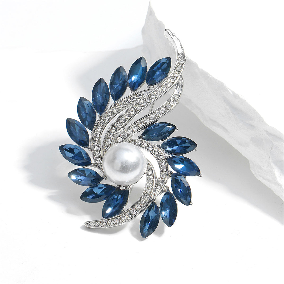 Elegant blue and white pearl and diamond brooch adorned with navy crystals and cubic zirconia in a botanical motif.
