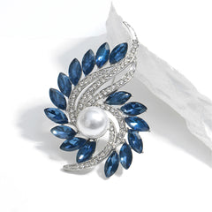 Elegant blue and white pearl and diamond brooch adorned with navy crystals and cubic zirconia in a botanical motif.