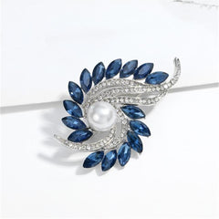 Exquisite blue and white pearl and diamond brooch, showcasing navy crystals and cubic zirconia in a botanical style.