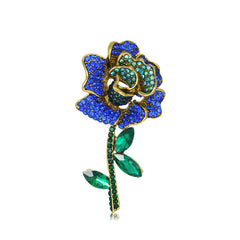 An exquisite blue and green crystal flower brooch adorned with blue cubic zirconia, crafted in 18K gold plating
